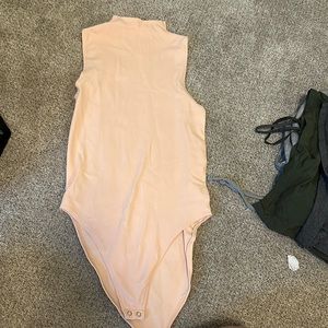 Brand new cream colored body suit from Just Fab. Never been worn